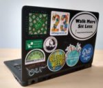 The back of a laptop, showing a selection of stickers.
